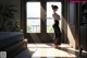 A woman standing in front of a door in a bedroom.