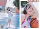 A woman in a white dress holding a basketball.